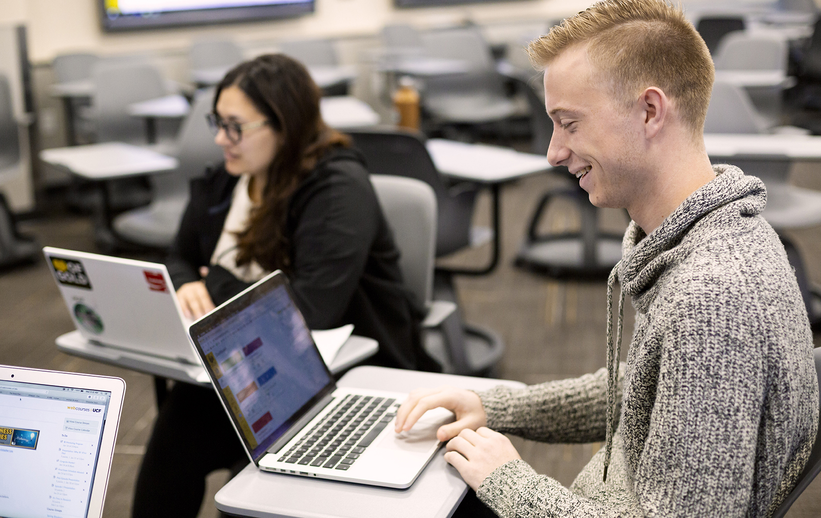 UCF students with laptops at desks