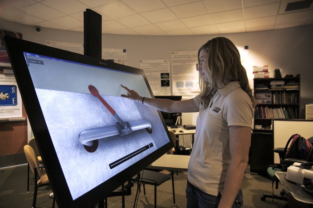 student in front of a touch screen