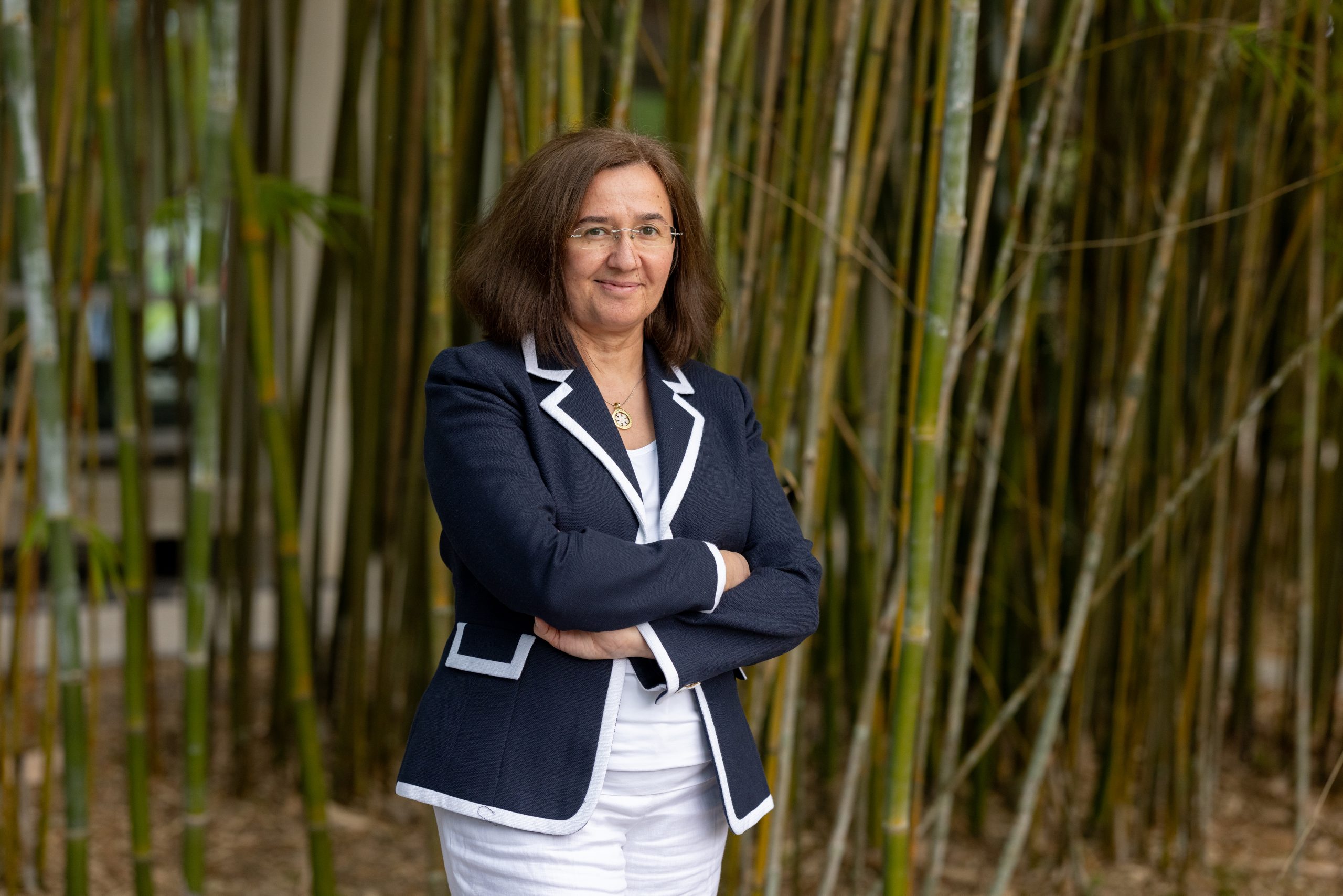 Damla Turgut posting in front of bamboo trees