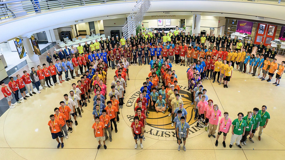 ICPC competitors stand in formation to spell "NAC" at the UCF Student Union